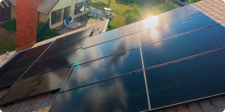 Solar panels arranged on a roof, converting sunlight into clean energy for the building.