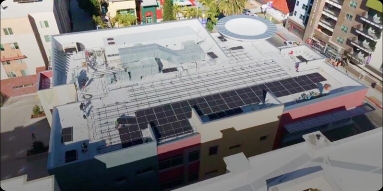 Solar panels on the roof of a city building, promoting clean energy and environmental sustainability in Southern California.